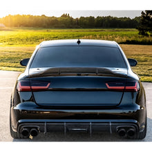 Carbon fiber trunk spoiler installed on black Audi A6 - rear view