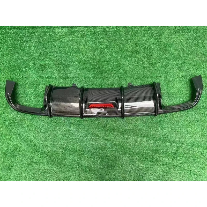 Carbon fiber rear diffuser on textured background - side view