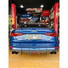 Carbon fiber rear diffuser installed on blue Audi A5 - rear view in shop