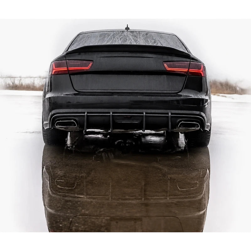 Carbon fiber ducktail spoiler installed on black Audi A6 - rear view in winter scene