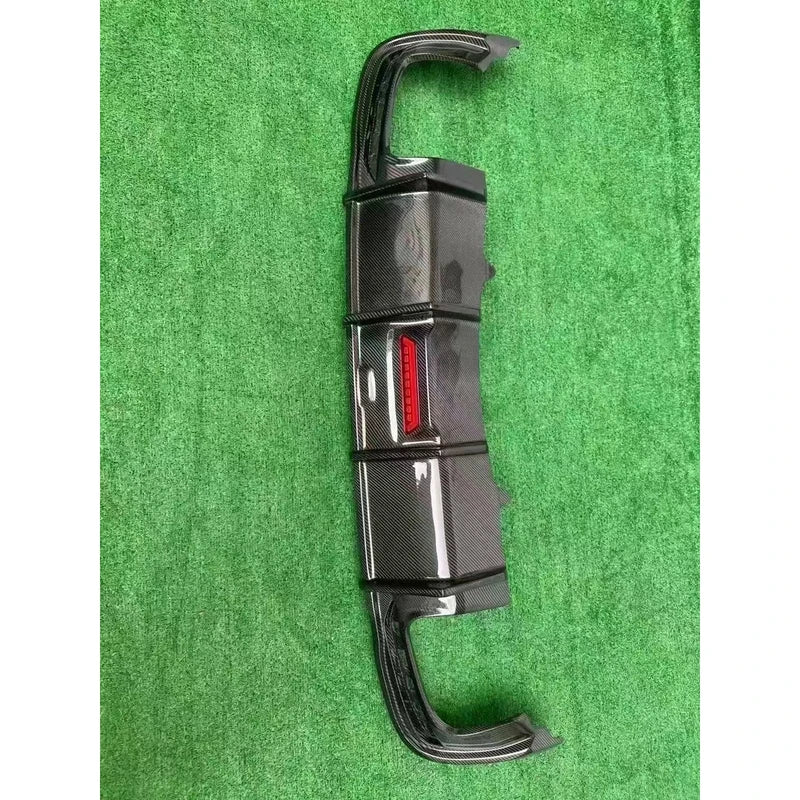 Carbon fiber rear diffuser on textured background - vertical view