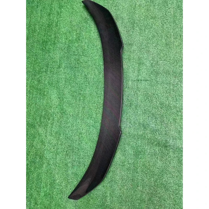V Style carbon fiber trunk spoiler on textured background - top view
