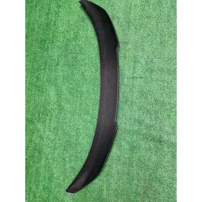 V Style carbon fiber trunk spoiler on textured background - top view