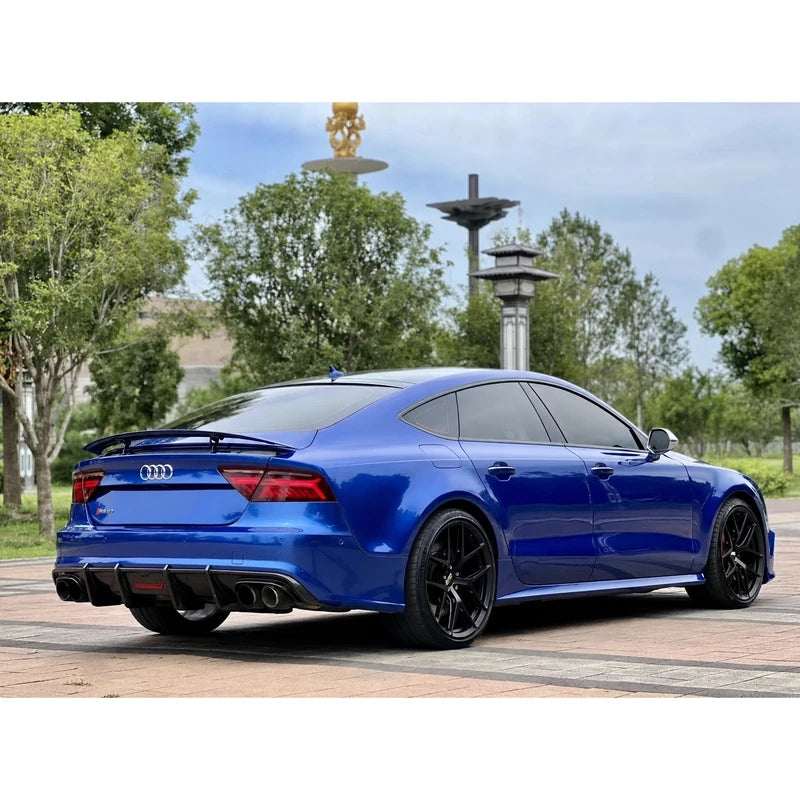 Carbon fiber rear diffuser installed on blue Audi A7 - side three-quarter view