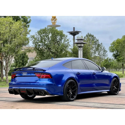 Carbon fiber rear diffuser installed on blue Audi A7 - side three-quarter view