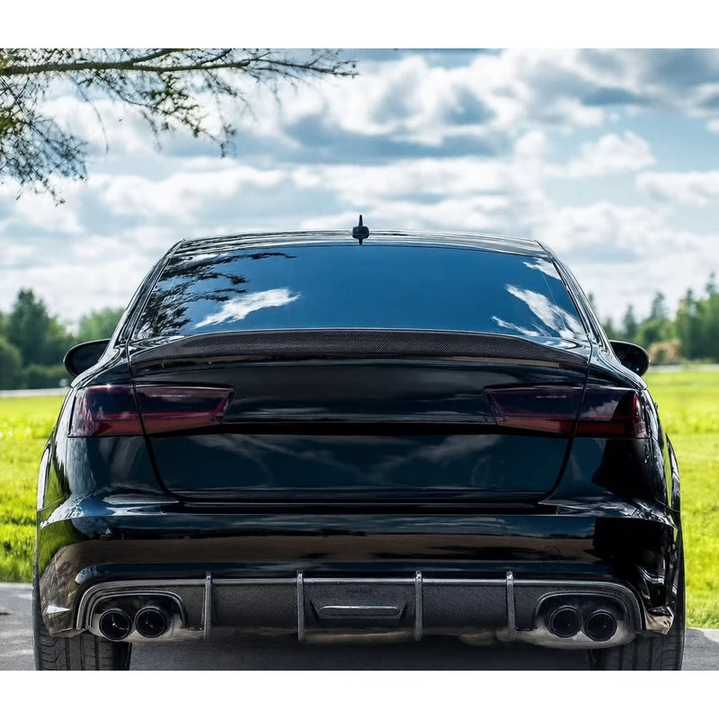 Carbon fiber ducktail spoiler installed on black Audi A6 - rear view with quad exhaust
