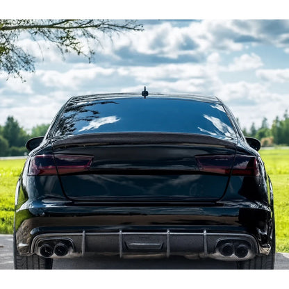 Carbon fiber ducktail spoiler installed on black Audi A6 - rear view with quad exhaust