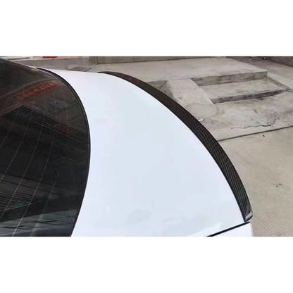 Carbon fiber lip spoiler installed on white Audi A6 - close-up