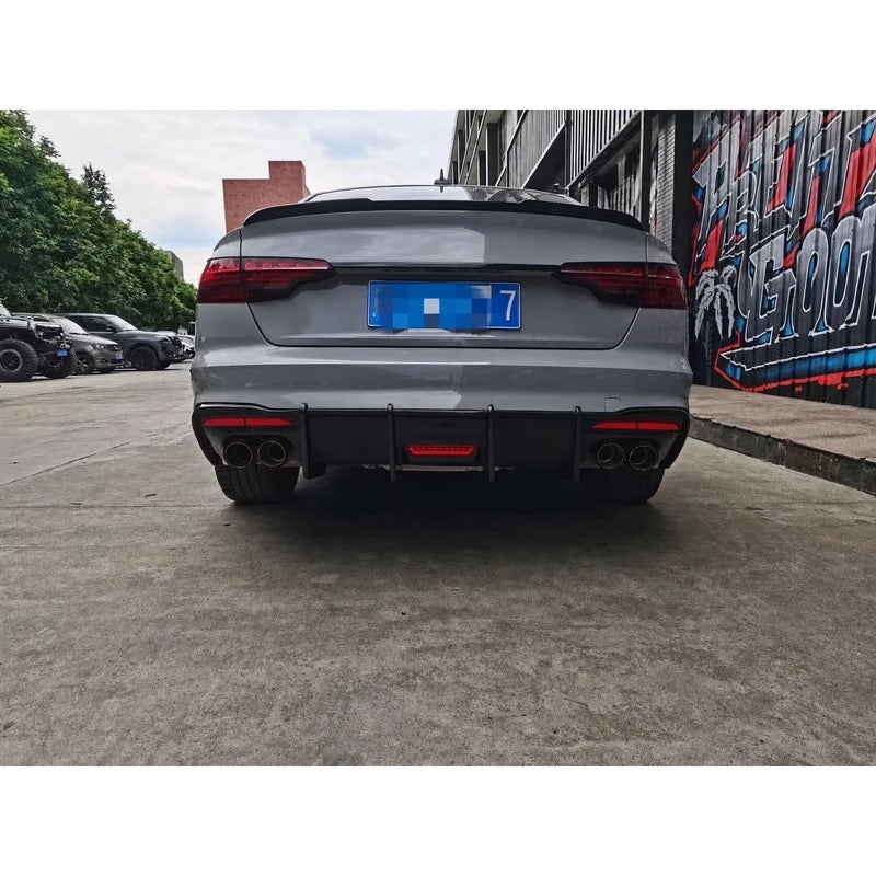 Carbon fiber rear diffuser installed on silver Audi A4 - rear view