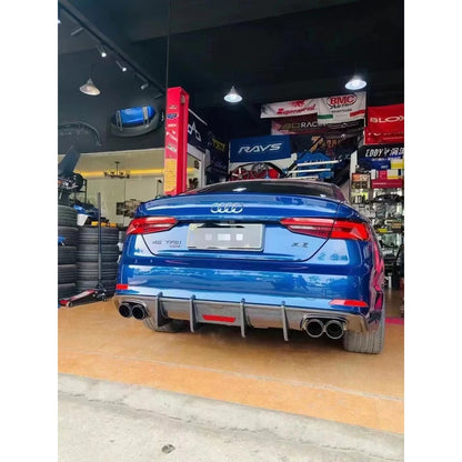 Carbon fiber rear diffuser installed on blue Audi A5 - wider rear view