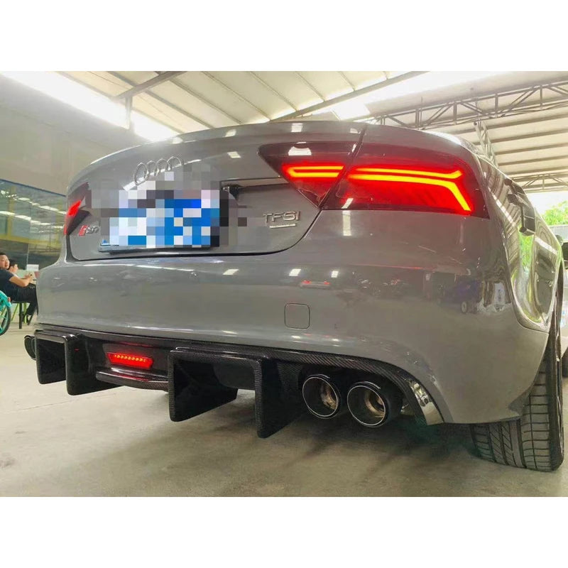 Carbon fiber rear diffuser installed on gray Audi A7 - rear three-quarter view