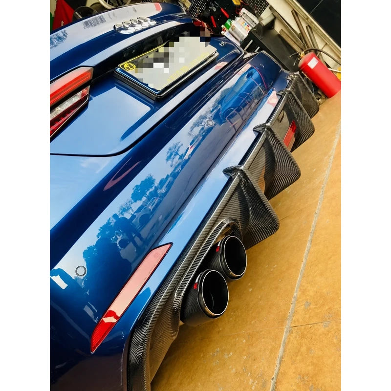 Carbon fiber rear diffuser installed on blue Audi A5 - close-up