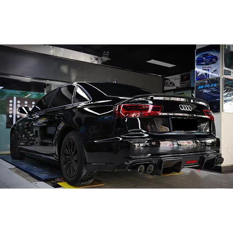 Carbon fiber rear diffuser installed on black Audi A6 - three-quarter view
