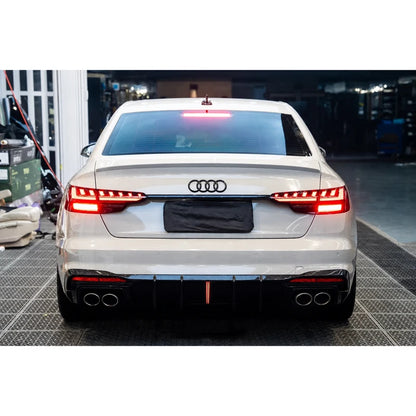 Carbon fiber rear diffuser installed on white Audi A4 - garage rear view